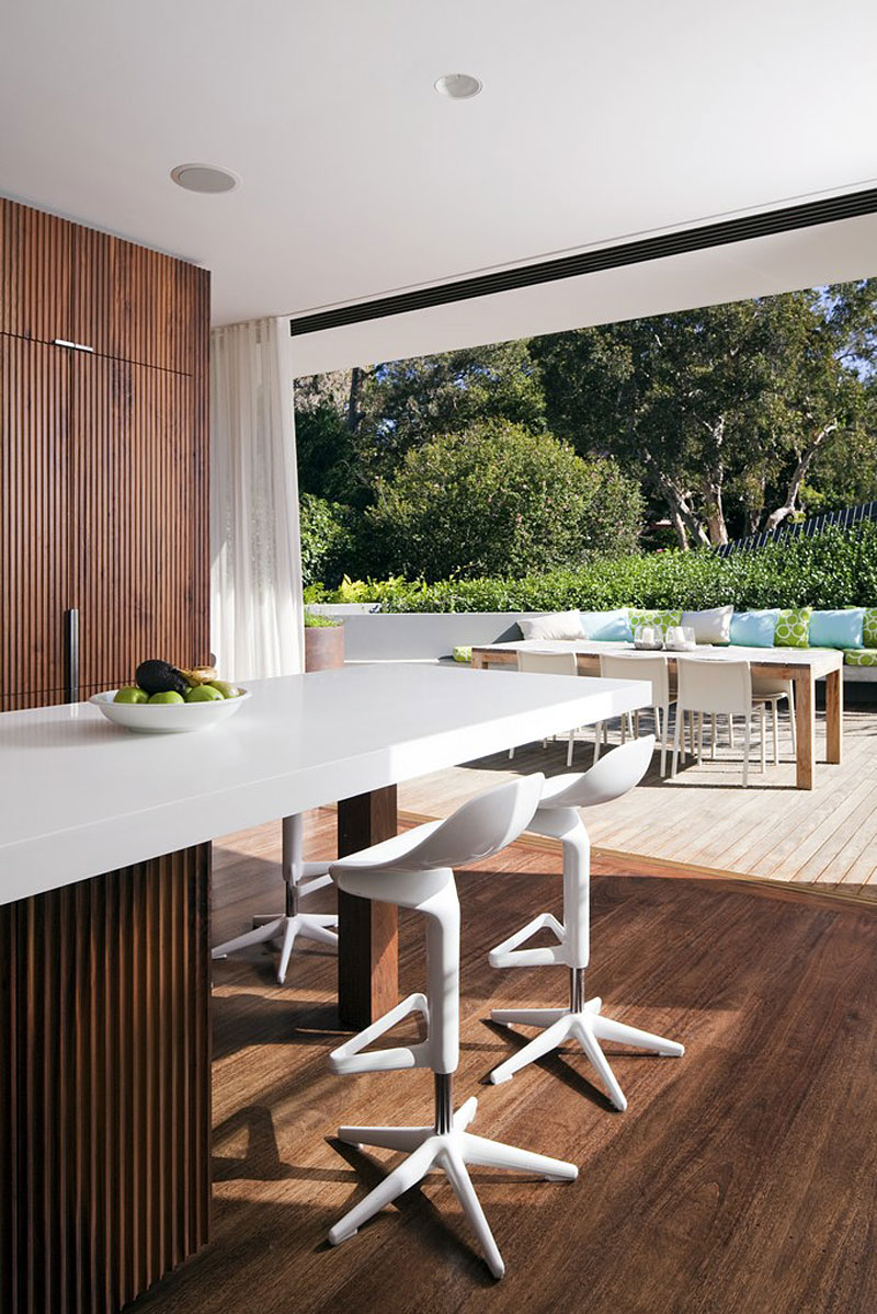 Honiton Residence White Accomplished Honiton Residence Decoration Included White Melamine Countertop Three Porcelain Barstools Wooden Partition And Hardwood Floor Residence Luxurious Contemporary Home In Australia With A Stylish Design