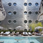 Outside Swimming In Amazing Outside Swimming Pool Located In Front Of Perforated Dream Downtown Hotel Wall Building With Some Lounge Chairs  Architecture  Amazing Hotel Building With Metal Panels 