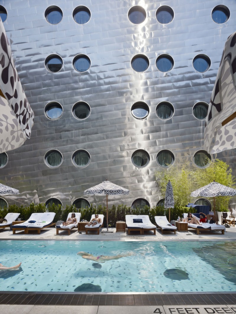 Outside Swimming In Amazing Outside Swimming Pool Located In Front Of Perforated Dream Downtown Hotel Wall Building With Some Lounge Chairs  Architecture  Amazing Hotel Building With Metal Panels 