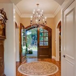 Chandelier Hanged Entryway Awesome Chandelier Hanged Above Round Entryway Carpet With Wooden Doors And Hardwood Floor Under White Ceiling Decoration  Entryway Rug Designs Applied In Some Spots 