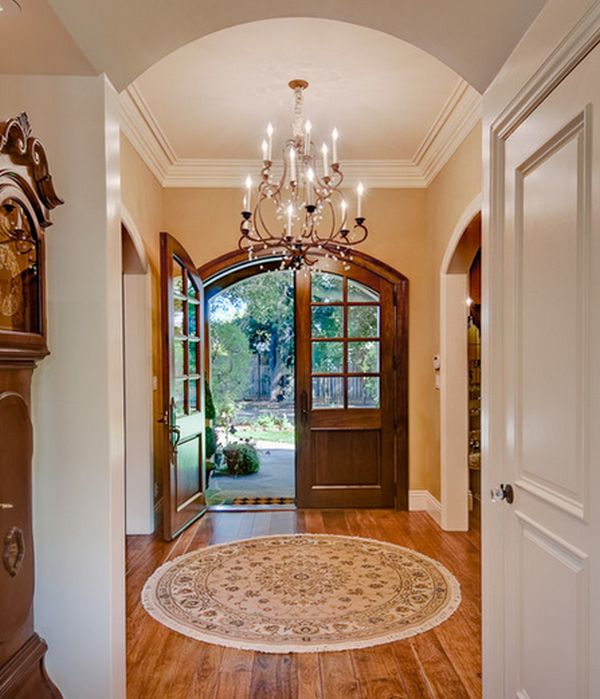 Chandelier Hanged Entryway Awesome Chandelier Hanged Above Round Entryway Carpet With Wooden Doors And Hardwood Floor Under White Ceiling Decoration  Entryway Rug Designs Applied In Some Spots 