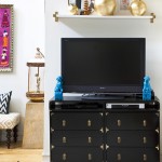 Dressers With Placed Black Dressers With Brass Detail Placed In Living Room As TV Stand Under Open Shelf Interior Design  Unique Dressers Style For Decorating Modern Interior Design 