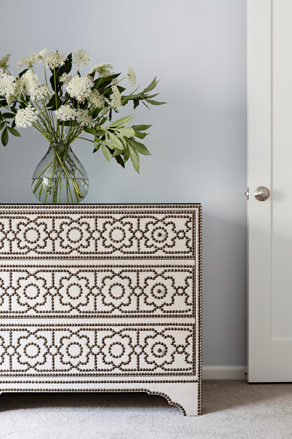 With Engraved The Dresser With Engraved Detail Covering The Surface Displaying Fresh Flowers Arranged Inside Glass Vase Decoration  Stylish Dresser Design To Decorate Room Design 