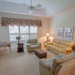 Family Room To Elegant Family Room With Wall To Wall Carpet And Vaulted Ceiling Design Furnished With Leather Sofa And Velvet Armchairs  Modern Contemporary House Model With Comfortable Interior 