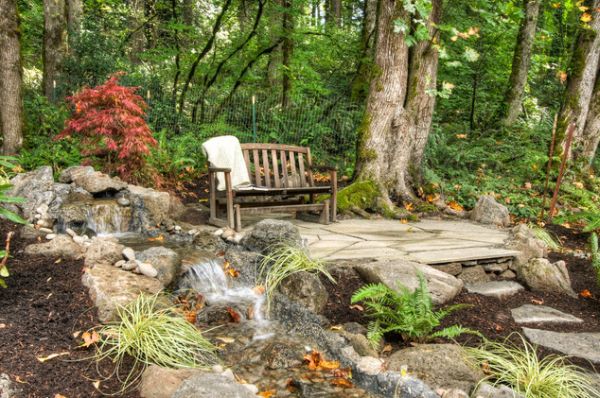 Open Space Including Exciting Open Space Lounge Corner Including Wooden Chair On Rough Stoney Ground Also Rocks Waterfall With Trees And Plants At Backside Garden  Backyard Garden Waterfalls As Beautiful Garden Landscaping 