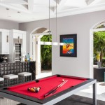 Playing Room Billiard Fascinating Playing Room Furnished With Billiard Table Under Pendant Lamps Near Kitchen Bar Also White Stools On Floor And Painting On Wall Decoration  Exclusive Modern Glamour House With The Application Of Bold Colours 