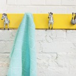 Yellow Painted Towel Fascinating Yellow Painted Zebra Rack Towel Installed On White Painted Brick Wall Beautified Decorative Hooks Decoration  DIY Coat Rack Decoration For Beautiful Interior Decoration 
