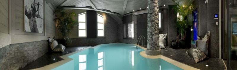 Indoor Swimming The Lovely Indoor Swimming Pool In The Chalet White Pearl With Stone Pillar Abd Indoor Plants Also Artistic Wall Painting Decoration  Casual Home Design With Cozy Room Atmosphere 