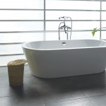 Free Standing Decorated Minimalist Free Standing Bath Tubs Decorated With White Modern Style And Concrete Tile Flooring And Small Wooden Table Free Standing Bath Tubs With Gorgeous Design And Style