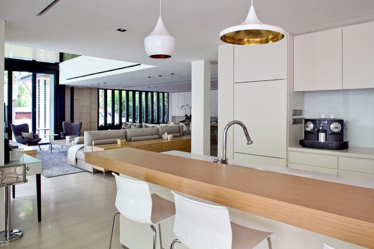 Kitchen In Ongong Sleek Kitchen In Tree Hill Ongong With White Coffee Table And Wooden Top Table White Pendant Lamps Above Interior Design  Delicate Bright Interior Inside A House With Elegant Design 