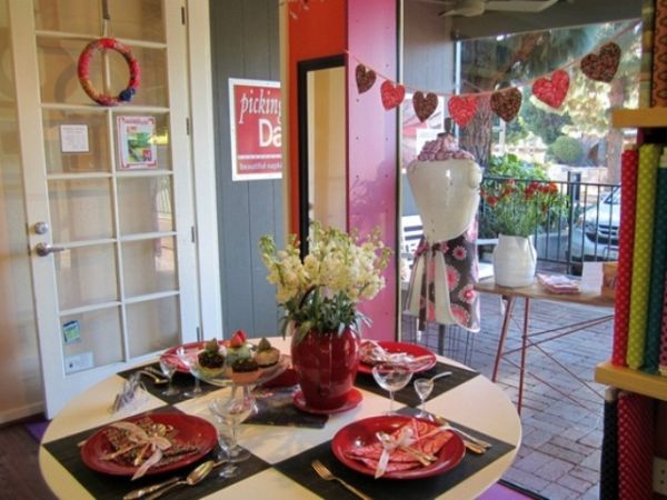 Round White The Small Round White Table Decorate The Room For Valentines Day With Some Red Plates And White Flowers Decoration  Tablescape Design For Celebrating Valentine’s Day 