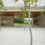 Trees On Itatiba Small Trees On GRavels At Itatiba Residence Roccovidal Garden Open Space To Kitchen Applied Wood Stools And Stone Wall Interior Design  Warm Interior Design From A Modern Home With Dim Lighting 