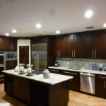 Island And Cabinets Wooden Island And Wooden Kitchen Cabinets In The Kitchen With Some Bright Lamps Kitchen  Modern Kitchen Cabinets With Additional Decorations 