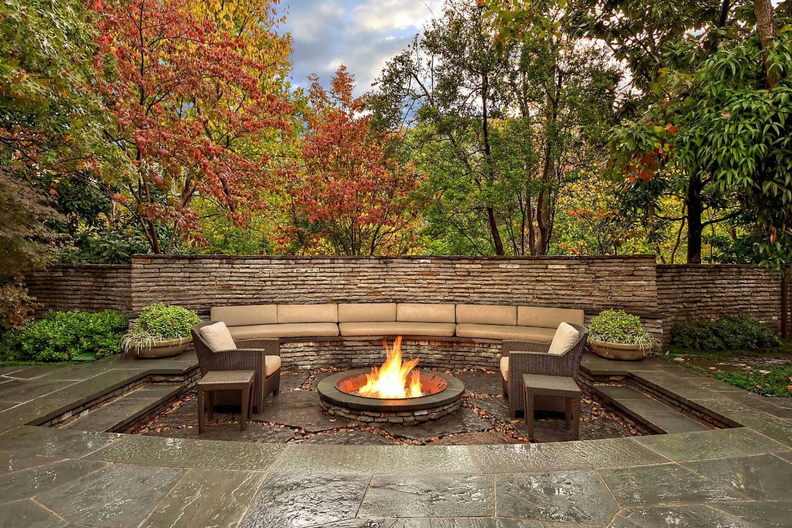 Design Of Living Backyard Design Of An Outdoor Living Spaces With A Bonfire Area On A Granite Floor Long Couches Chairs And Tables Outdoor Charming Outdoor Living Spaces For Your Modern Dwelling