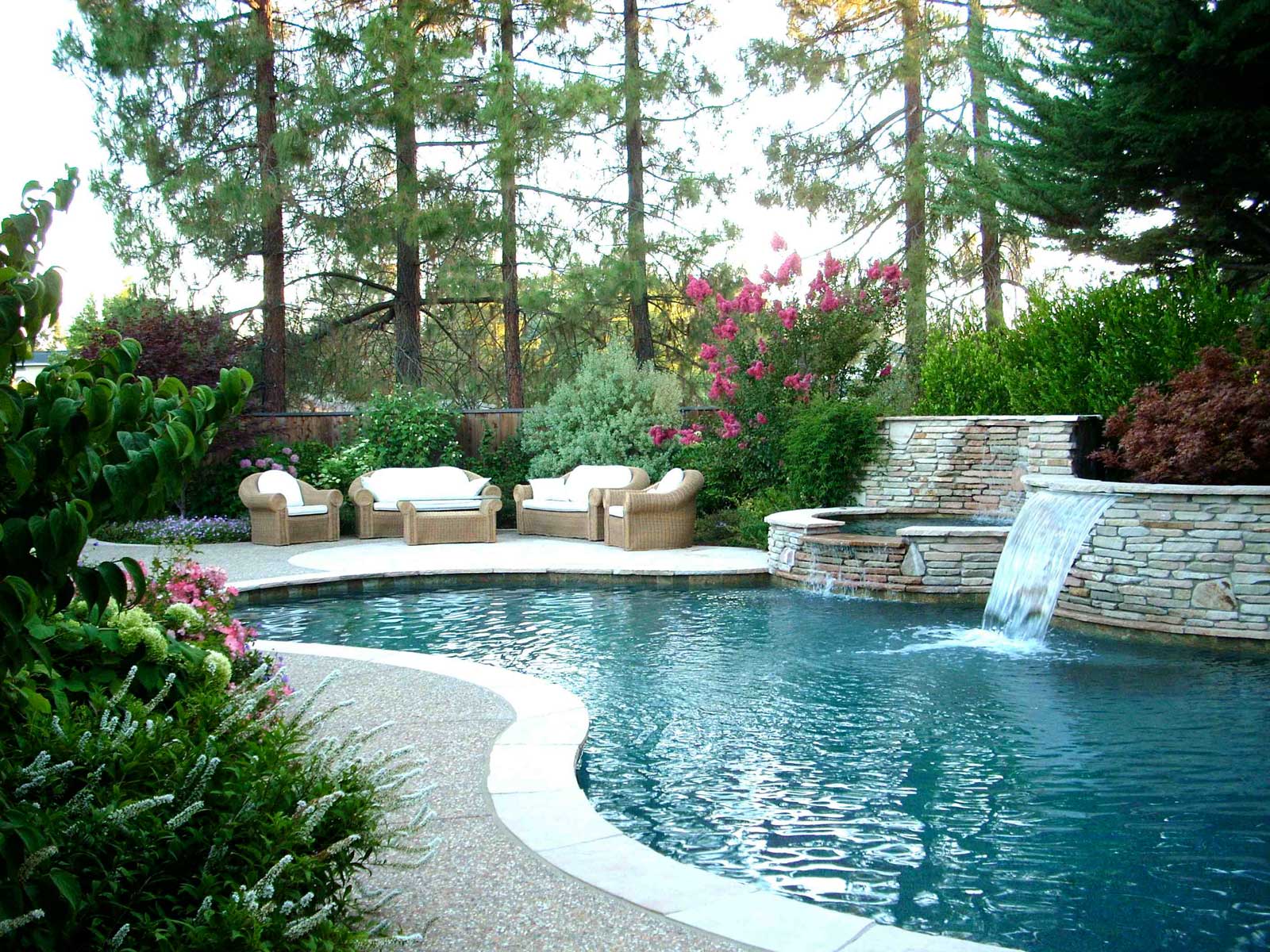 Landscape Design Ideas Backyard Landscape Design With Pool Ideas Using Small Waterfall And Wicker Sofa For Outdoor Furniture Ideas Inspiration Outdoor Backyard Landscape Design To Make The Most Of Your Space