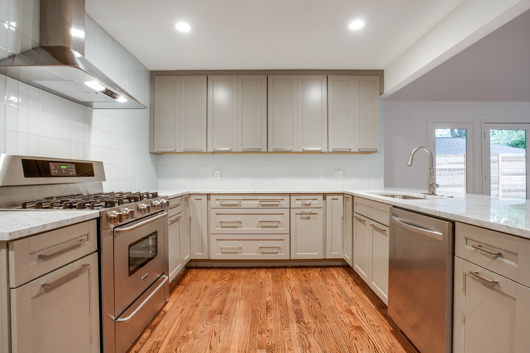Wood Laminate With Breathtaking Wood Laminate Flooring Combined With White Furniture Completed With Sectional Cupboard Furnished With Sink And Oven Range With Countertop Interior Design Wood Laminate Flooring Design In Home Interior