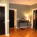 Entrance With Combined Captivating Entrance With Wooden Flooring Combined With Black Interior Doors Furnished With Table Completed With Table Decorations Plus Added With Table Lighting Interior Design Black Interior Doors And Its Elegant Appearance