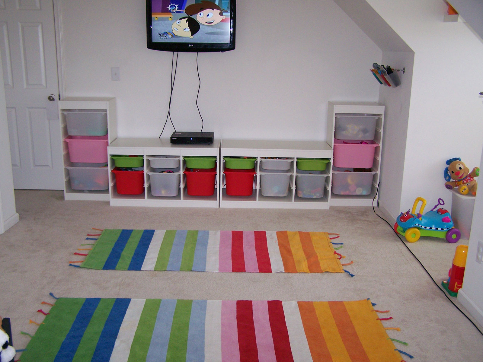 Kids Room Wall Charming Kids Room Applying White Wall Color Furnished With Cupboards Of Kids Room Storage Completed With Wall TV And Rug In Colorful Striped Color Kids Room The Two Ideas For Making The Kids Room Storage