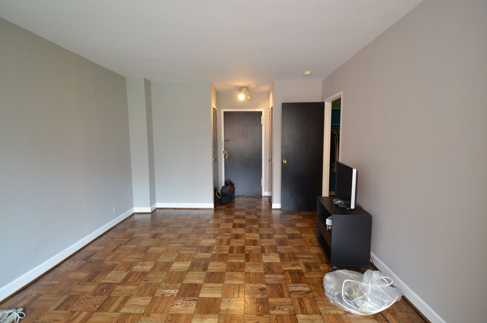 Entrance Applying Tile Cool Entrance Applying Wooden Flooring Tile Combined With White Wall Paint Color Furnished With Black Interior Doors And Completed With Flat Screen TV On Cupboard Interior Design Black Interior Doors And Its Elegant Appearance