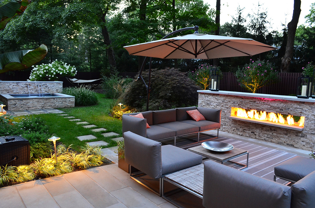 Patio In Design Dazzling Patio In Backyard Landscape Design With Electric Fireplace Furnished With Grey Sofa Also Chairs And Table Plus Completed With Umbrella Decoration Backyard Landscape Design: Decorating The Space