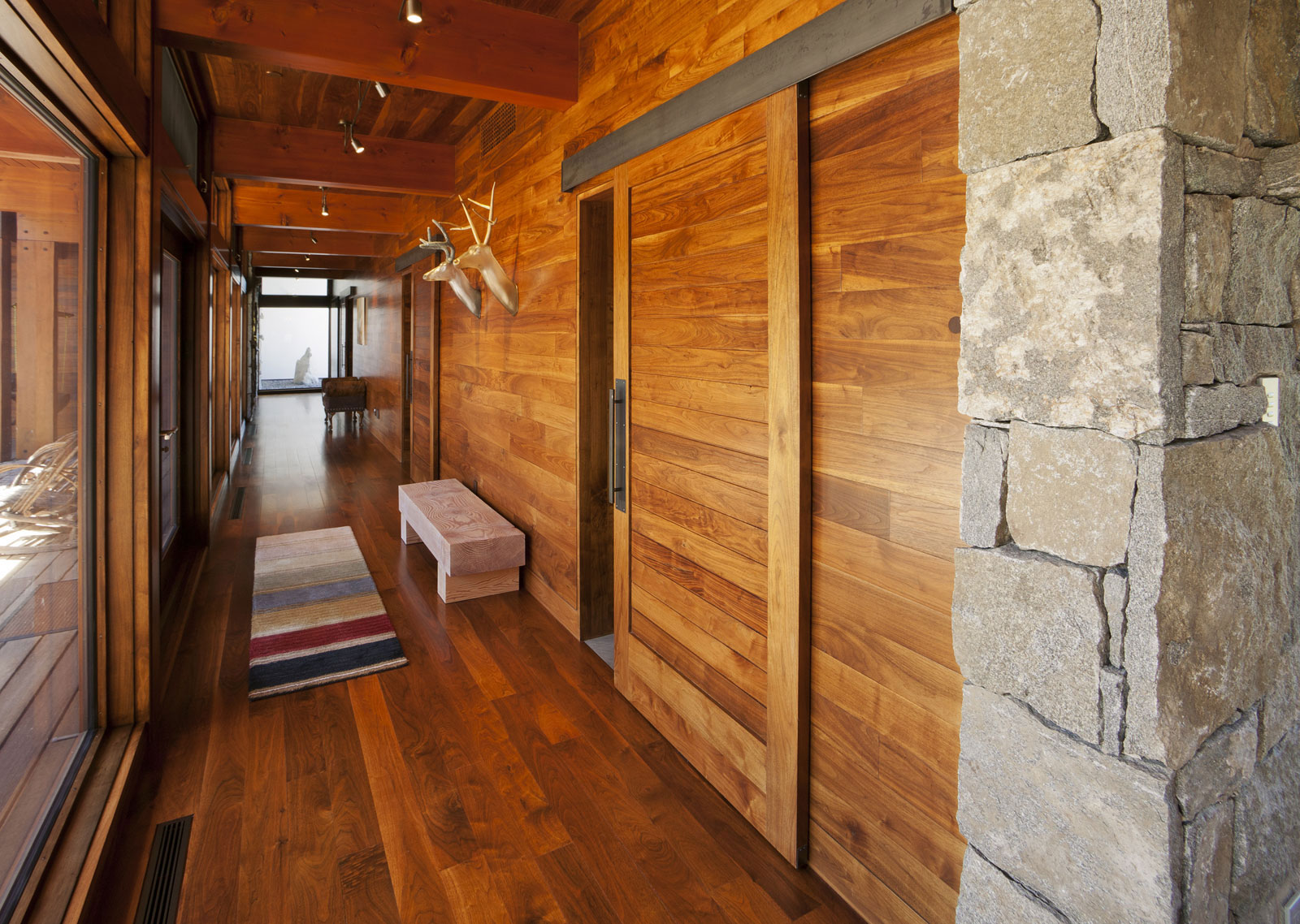 Entrance Applying Also Enchanting Entrance Applying Wooden Wall Also Flooring With Sliding Interior Wood Doors And Furnished With Faux Deer Head Of Wall Decorations And Completed With Bench Interior Design The Possible Combination Of The Interior Wood Doors