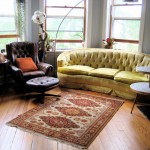 Wooden Flooring Living Enchanting Wooden Flooring Applied In Living Room With Yellow Sofa And Dark Brown Chair With Ottoman Completed With Round Ottoman And Living Room Rugs Living Room How To Choose Special Living Room Rugs