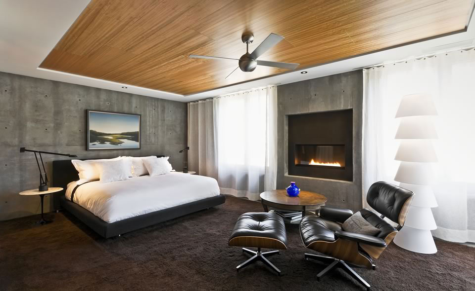Master Bedroom Exposed Large Master Bedroom Design With Exposed Concrete Wall Wooden Ceiling And White Bed With Brown Carpet Tiles Plus Black Leather Eames Lounge Chair And Round Table With Bookshelf Ideas Architecture Sophisticated Concrete And Steel Modern Home With Glass Elements