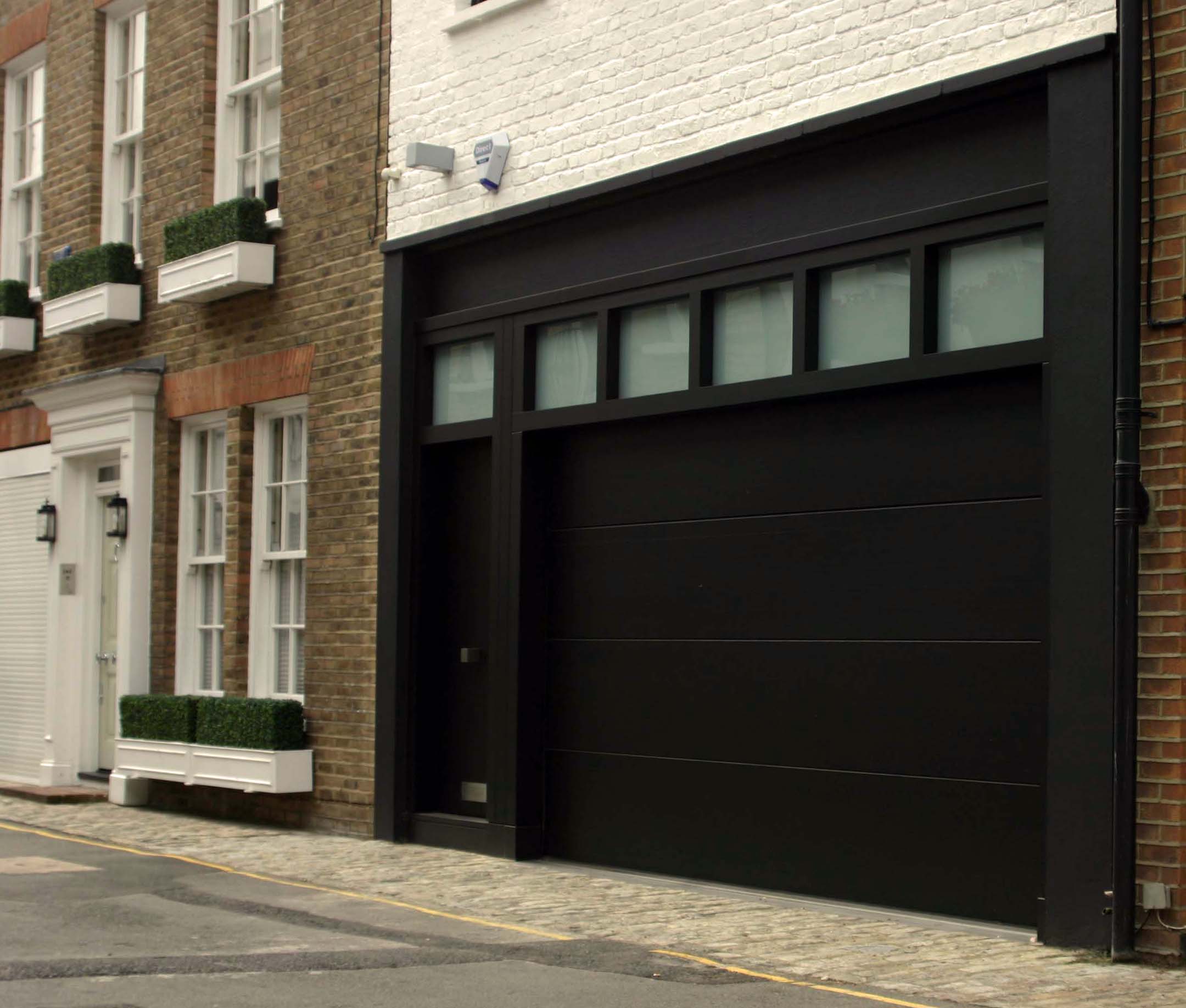 Design Of English Marvelous Garage Design Of A Classic English House With White Painted Brick Walls Black Sliding Garage Door Exterior Elegant Sliding Garage Doors In Natural Colour
