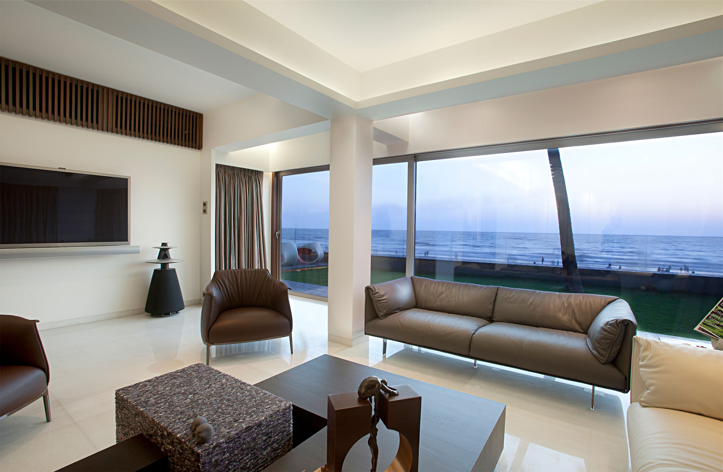 Living Room Design Open Living Room Beach Apartment Design With Brown Leather Sofa And Chairs Plus Glass Window With Curtains And Wall Mounted TV Ideas Apartment Stylish Beach Apartment With Stunning Terrace And Ocean View