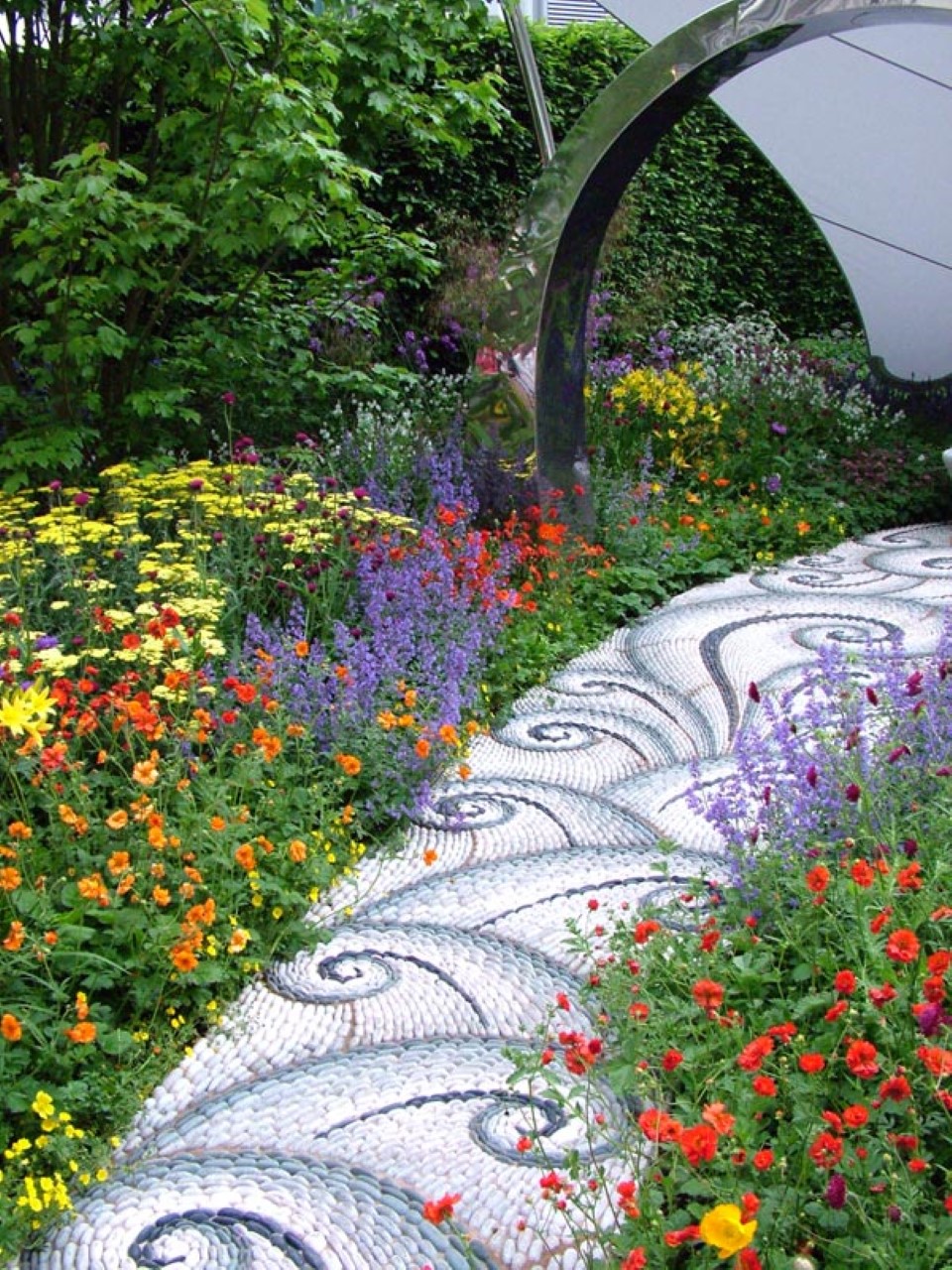 Stainless Steel With Sleek Stainless Steel Archway Combined With Adorable Color Flowery Plants And Comely Garden Path Garden Making A Wonderful Garden Path Ideas Using Stones