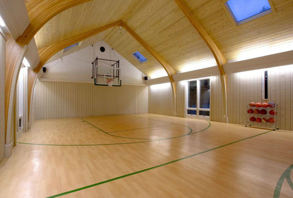 Indoor Basketball Vaulted Unusual Indoor Basketball Court With Vaulted Ceiling And Square Skylights Feat Laminate Floor Plus Portable Ball Racks  Fascinating Indoor Basketball Court Ideas 