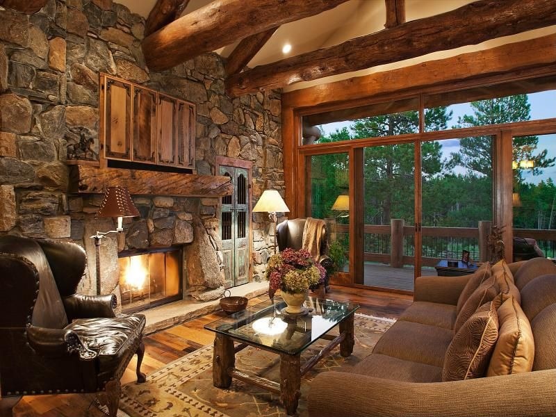 Of A Room View Of A Stunning Living Room With Wooden Floor Leather Couches Coffee Table Stone Walls And Fireplace For Rustic Living Room Ideas Living Room Majestic Rustic Living Room With Delicate Beauty