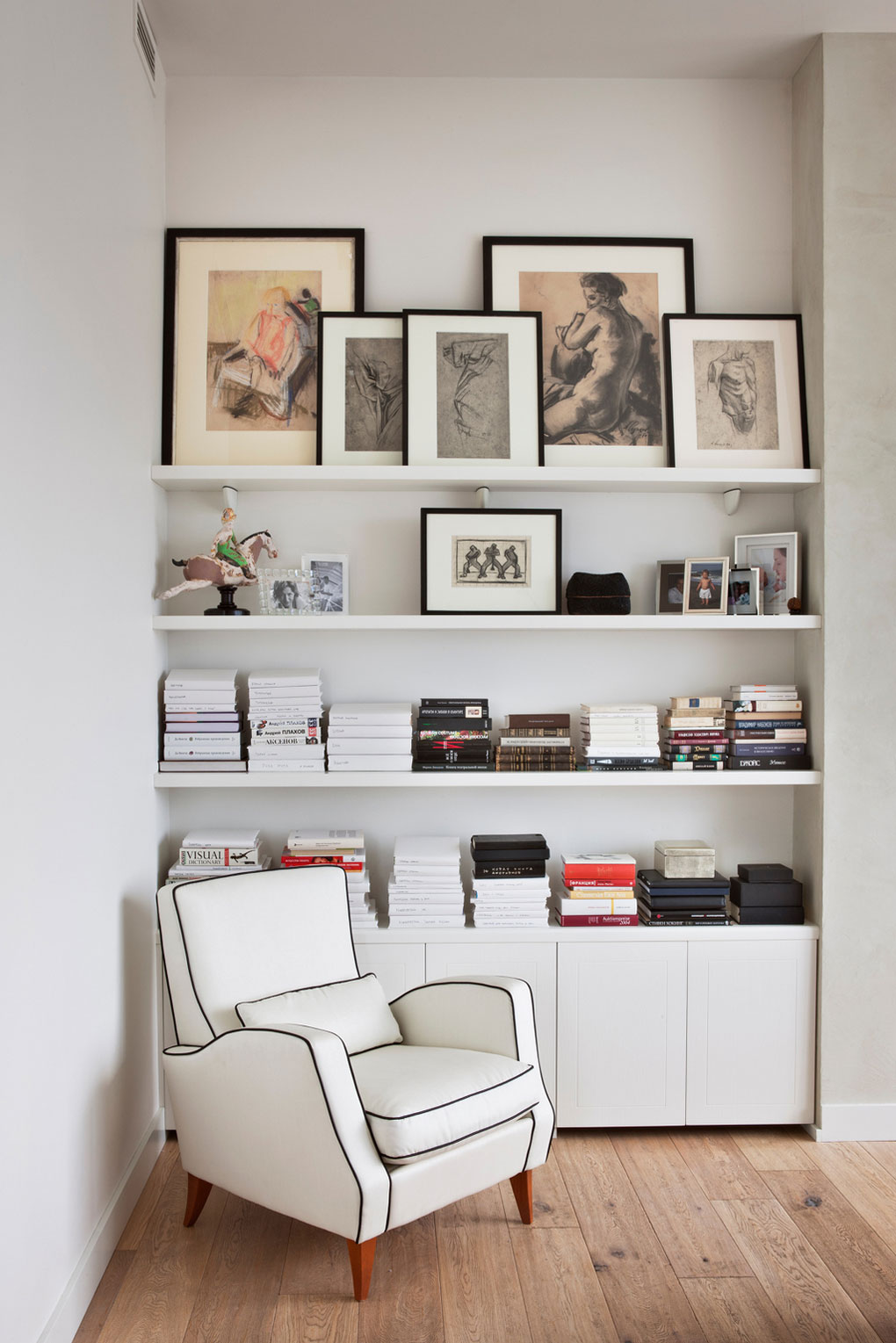 Leather Armchair Of White Leather Armchair In Front Of Corner Wall Shelving Units With Picture Frame And Cabinets Apartment Quirky And Eclectic Apartment Looking Over The Red City