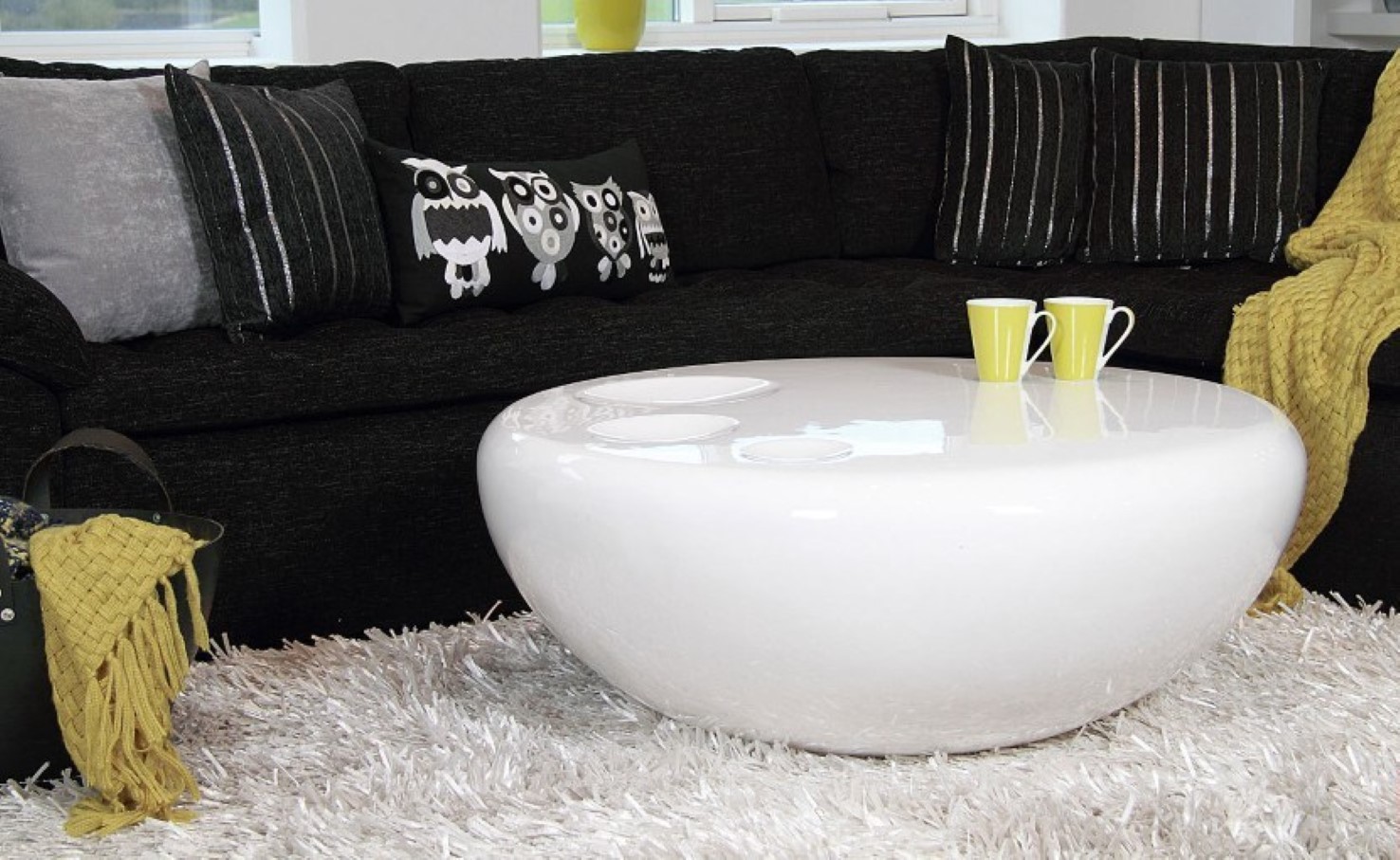 Modern Round And Ultra Modern Round Coffee Table And Fluffy White Living Room Rug Idea Feat Awesome Curved Black Sofa With Owl Pillowcase Furniture  Free And Relaxing To Gather Round The Coffee Table 